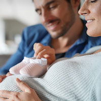 Mother and father to be at home expecting baby girl